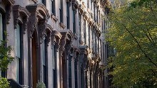 A row of brownstones on a street in brooklyn.