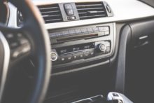 Car interior with radio and steering wheel.