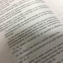 Debtor's Bankruptcy Discharge Revoked for Failure to Turnover Inheritance An open book featuring bankruptcy.