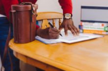 Bankruptcy Debtors Should Not E-Sign Their Papers, says Bankruptcy Court A debtor signing with an e-signature in a notebook at a table.