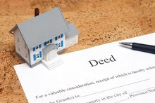 A deed of trust and a pen, illustrating the process of changing a deed.