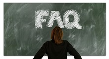 A woman consulting a chalkboard labeled 